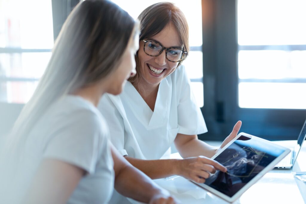 gynecologist-doctor-showing-to-pregnant-ultrasound-scan-baby-with-digital-tablet-in-consultation-.jpg